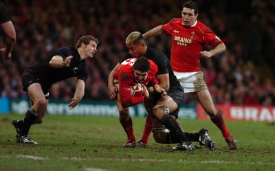 25.11.06 - Wales v New Zealand - Invesco Perpetual Series 2006 - Wales' James Hook is tackled by New Zealand's Jerry Collins 