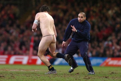 25.11.06 - Wales v New Zealand - Invesco Perpetual Series 2006 - A steward tries to tackle a streaker 