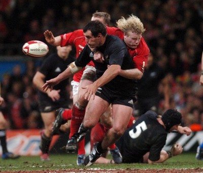 25.11.06 - Wales v New Zealand New Zealand's Carl Hayman spills the ball as Duncan Jones 