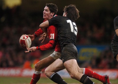25.11.06 - Wales v New Zealand Wales' James Hook releases the ball as Conrad Smith tackles 