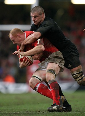 25.11.06..Wales v New Zealand, Invesco Perpetual Series '06 Wales' Martyn Williams is tackled by Keith Robinson 
