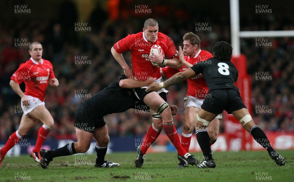 25.11.06..Wales v New Zealand, Invesco Perpetual Series '06 Wales' Ian Evans is tackled by Anton Oliver and Rodney So'oialo 