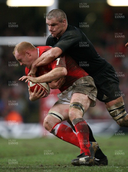 25.11.06..Wales v New Zealand, Invesco Perpetual Series '06 Wales' Martyn Williams is tackled by Keith Robinson 