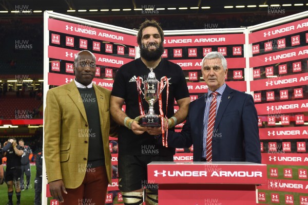 251117 - Wales v New Zealand - Under Armour Series - Samuel Whitelock of New Zealand receives the winners trophy from WRU Chairman Gareth Davies (right)