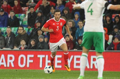 240316 - Vauxhall International Friendly - Wales v Northern Ireland -Adam Matthews of Wales takes on Gareth McAuley of Northern Ireland