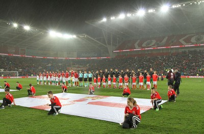 240316 - Vauxhall International Friendly - Wales v Northern Ireland -Players of Wales and Northern Ireland line up for the anthems
