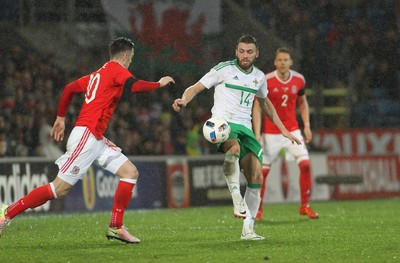 240316 - Vauxhall International Friendly - Wales v Northern Ireland -Stuart Dallas of Northern Ireland beats Tom Lawrence of Wales to the ball