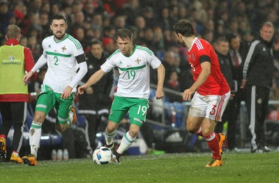 240316 - Vauxhall International Friendly - Wales v Northern Ireland -Jamie Ward of Northern Ireland takes on Adam Matthews of Wales