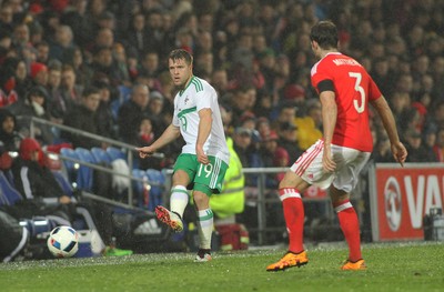 240316 - Vauxhall International Friendly - Wales v Northern Ireland -Jamie Ward of Northern Ireland threads a pass past Adam Matthews of Wales