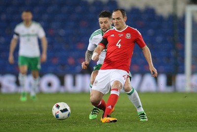 240316 - Wales v Northern Ireland, International Friendly -David Vaughan of Wales holds off Oliver Norwood of Northern Ireland
