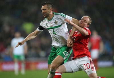240316 - Wales v Northern Ireland, International Friendly - Jonathan Williams of Wales and Gareth McAuley of Northern Ireland tangle as the compete for the ball
