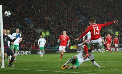 240316 - Wales v Northern Ireland, International Friendly - Lloyd Isgrove of Walesgets a shot at goal as Conor McLaughlin of Northern Ireland challenges