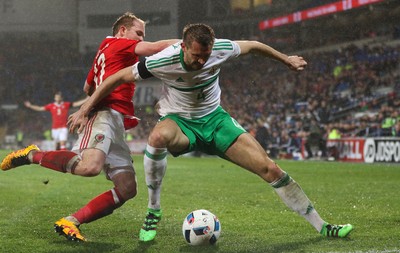 240316 - Wales v Northern Ireland, International Friendly - Jonathan Williams of Wales and Gareth McAuley of Northern Ireland compete for the ball