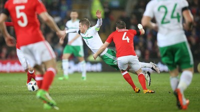 240316 - Wales v Northern Ireland, International Friendly - Steven Davis of Northern Ireland is brought down by David Vaughan of Wales