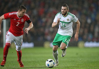 240316 - Wales v Northern Ireland, International Friendly - Stuart Dallas of Northern Ireland takes on Chris Gunter of Wales