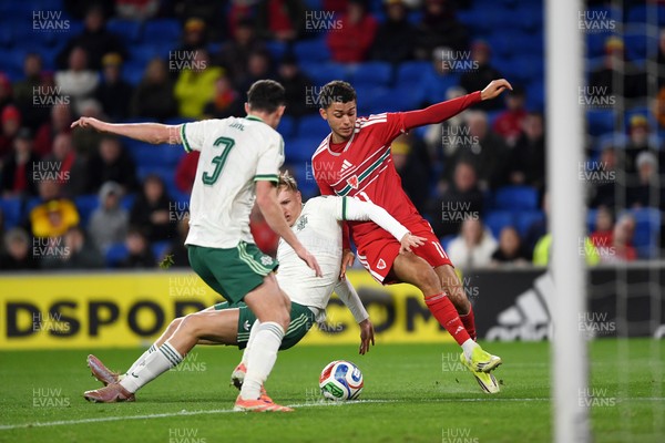 310326 - Wales v Northern Ireland - International Friendly - Brennan Johnson of Wales is challenged by Tom Atcheson of Northern Ireland