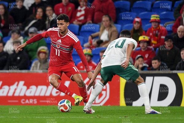 310326 - Wales v Northern Ireland - International Friendly - Brennan Johnson of Wales is challenged by Brodie Spencer of Northern Ireland