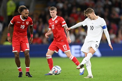 011026 - Wales v Norway - UEFA Nations League - Martin Odegaard of Norway is challenged by Sorba Thomas of Wales