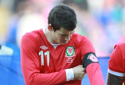 12.11.11 -  Wales v Norway, International Friendly -  Wales' Gareth Bale adjusts the black armband with the Poppy as the teams line up for the anthems 