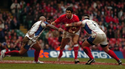 11.11.06 - Wales v Pacific Islanders - Invesco Perpetual Series - Wales' Mike Phillips is tackled by Pacific Islanders' Nili Latu and Justin Va'a (R) 