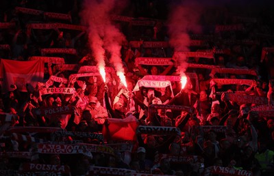 260324 - Wales v Poland, Euro 2024 qualifying Play-off Final - Polish fans set off flares during the anthem