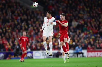 260324 - Wales v Poland, Euro 2024 qualifying Play-off Final - Robert Lewandowski of Poland and  Ben Davies of Wales compete for the ball