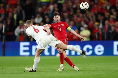 260324 - Wales v Poland, Euro 2024 qualifying Play-off Final - Ben Davies of Wales plays the ball past Jakub Piotrowski of Poland