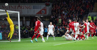 260324 - Wales v Poland, Euro 2024 qualifying Play-off Final - Kieffer Moore of Wales heads over the bar