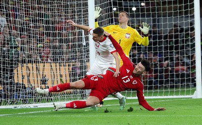 260324 - Wales v Poland, Euro 2024 qualifying Play-off Final - Kieffer Moore of Wales is challenged infant of goal