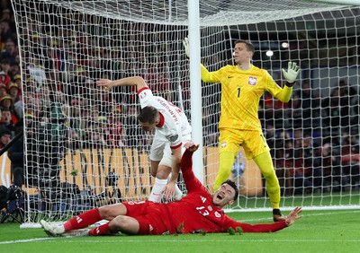 260324 - Wales v Poland, Euro 2024 qualifying Play-off Final - Kieffer Moore of Wales is challenged infant of goal