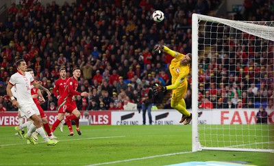 260324 - Wales v Poland, Euro 2024 qualifying Play-off Final - Wojciech Szczesny of Poland tips the attempt from Kieffer Moore of Wales past the post