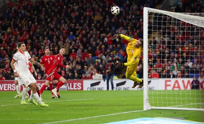 260324 - Wales v Poland, Euro 2024 qualifying Play-off Final - Wojciech Szczesny of Poland tips the attempt from Kieffer Moore of Wales past the post