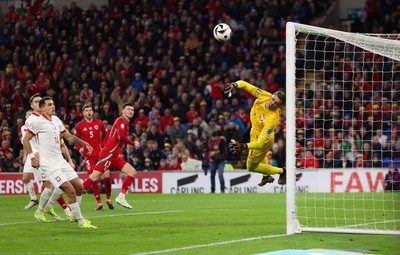 260324 - Wales v Poland, Euro 2024 qualifying Play-off Final - Wojciech Szczesny of Poland tips the attempt from Kieffer Moore of Wales past the post