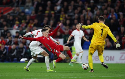 260324 - Wales v Poland, Euro 2024 qualifying Play-off Final - Harry Wilson of Wales challenges Wojciech Szczesny of Poland