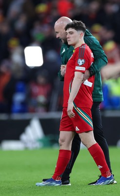 260324 - Wales v Poland, Euro 2024 qualifying Play-off Final - Daniel James of Wales is consoled after Wales lose the penalty shootout