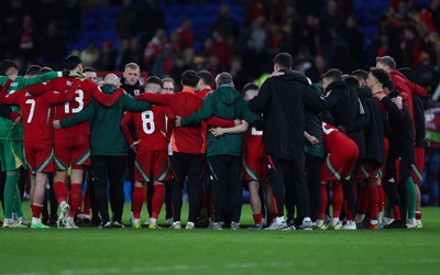 260324 - Wales v Poland, Euro 2024 qualifying Play-off Final - Wales huddle together after Wales lose the penalty shootout