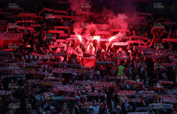 260324 - Wales v Poland, Euro 2024 qualifying Play-off Final - Polish fans set off flares during the anthem