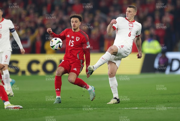 260324 - Wales v Poland, Euro 2024 qualifying Play-off Final - Jakub Piotrowski of Poland plays the ball past Ethan Ampadu of Wales