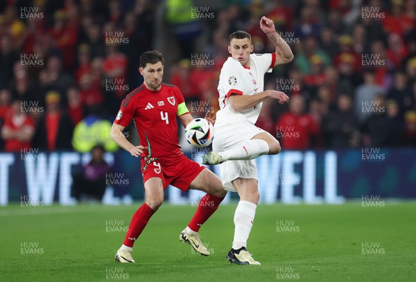 260324 - Wales v Poland, Euro 2024 qualifying Play-off Final - Jakub Piotrowski of Poland plays the ball past Ben Davies of Wales