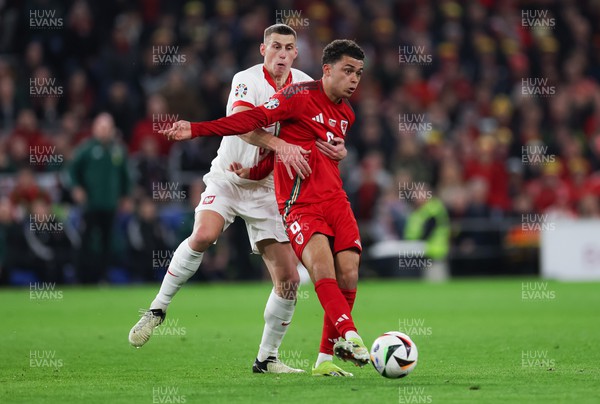 260324 - Wales v Poland, Euro 2024 qualifying Play-off Final - Brennan Johnson of Wales is challenged by Jakub Piotrowski of Poland
