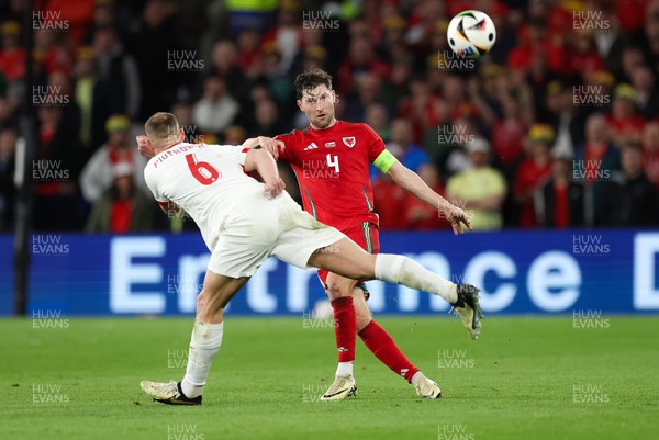 260324 - Wales v Poland, Euro 2024 qualifying Play-off Final - Ben Davies of Wales plays the ball past Jakub Piotrowski of Poland