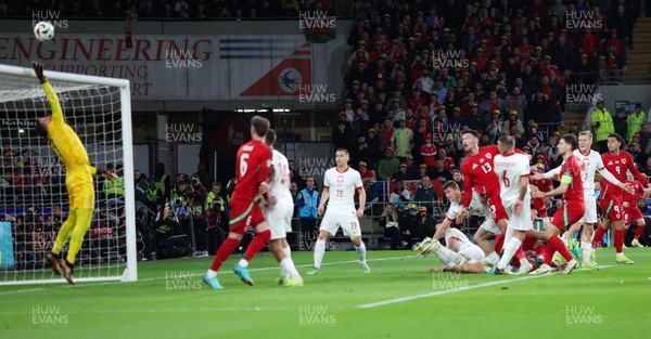 260324 - Wales v Poland, Euro 2024 qualifying Play-off Final - Kieffer Moore of Wales heads over the bar