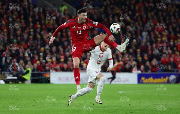 260324 - Wales v Poland, Euro 2024 qualifying Play-off Final - Kieffer Moore of Wales wins the ball from Piotr Zielinski of Poland