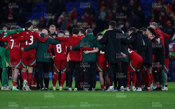 260324 - Wales v Poland, Euro 2024 qualifying Play-off Final - Wales huddle together after Wales lose the penalty shootout