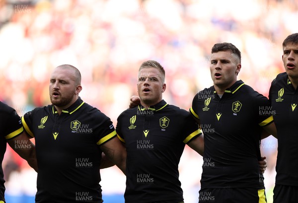 160923 - Wales v Portugal - Rugby World Cup France 2023 - Pool C - Dillon Lewis, Gareth Anscombe and Mason Grady of Wales sing the anthem