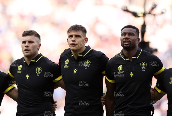 160923 - Wales v Portugal - Rugby World Cup France 2023 - Pool C - Mason Grady, Dafydd Jenkins and Christ Tshiunza of Wales sing the anthem