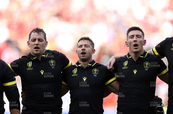 160923 - Wales v Portugal - Rugby World Cup France 2023 - Pool C - Ryan Elias, Leigh Halfpenny and Josh Adams of Wales sing the anthem