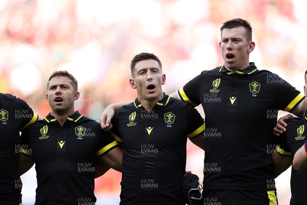 160923 - Wales v Portugal - Rugby World Cup France 2023 - Pool C - Leigh Halfpenny, Josh Adams and Adam Beard of Wales sing the anthem