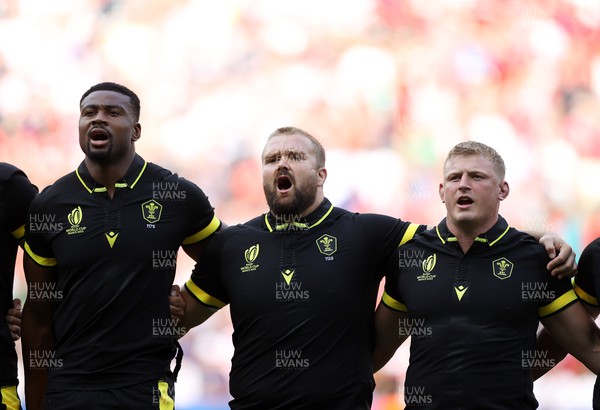 160923 - Wales v Portugal - Rugby World Cup France 2023 - Pool C - Christ Tshiunza, Tomas Francis and Jac Morgan of Wales sing the anthem