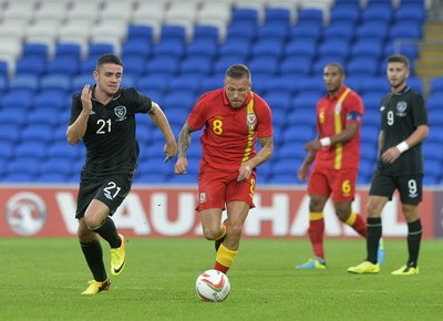 140813 - Wales v Republic of Ireland, International Friendly -   Craig Bellamy of Wales, right, is challenged for the ball by Robbie Brady of Ireland